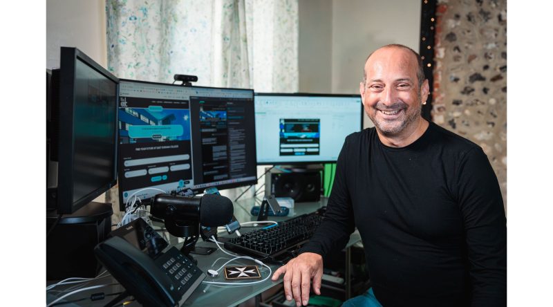 Clive is at his desk, smiling